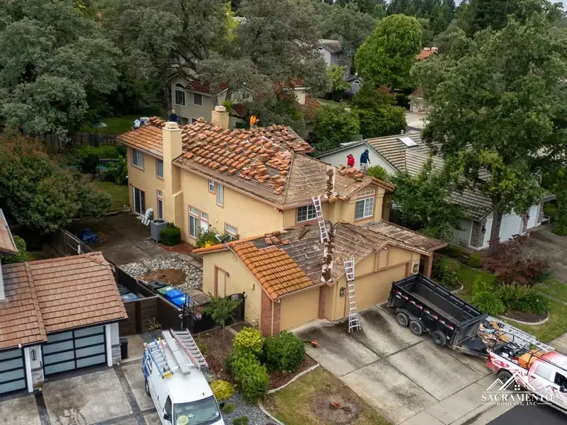 Tile roof tear-off in progress aerial view Haines City FL — tile replacement Polk County Florida licensed contractor